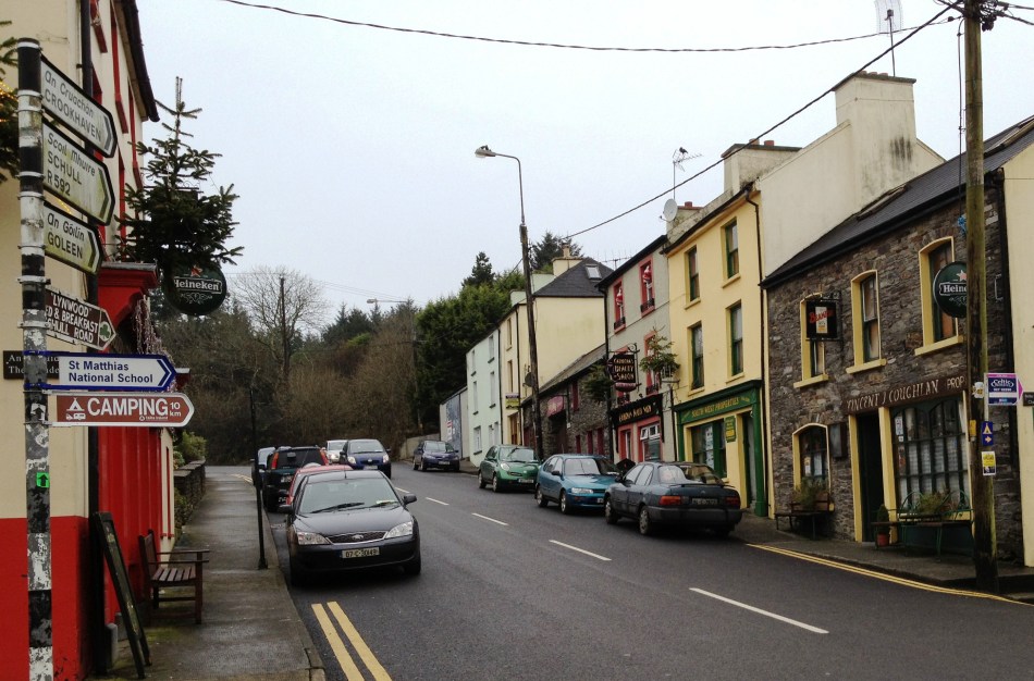 Directional signs in Irish and English, cars parked every which way, street names in small print on the wall. Welcome to driving in Ireland!