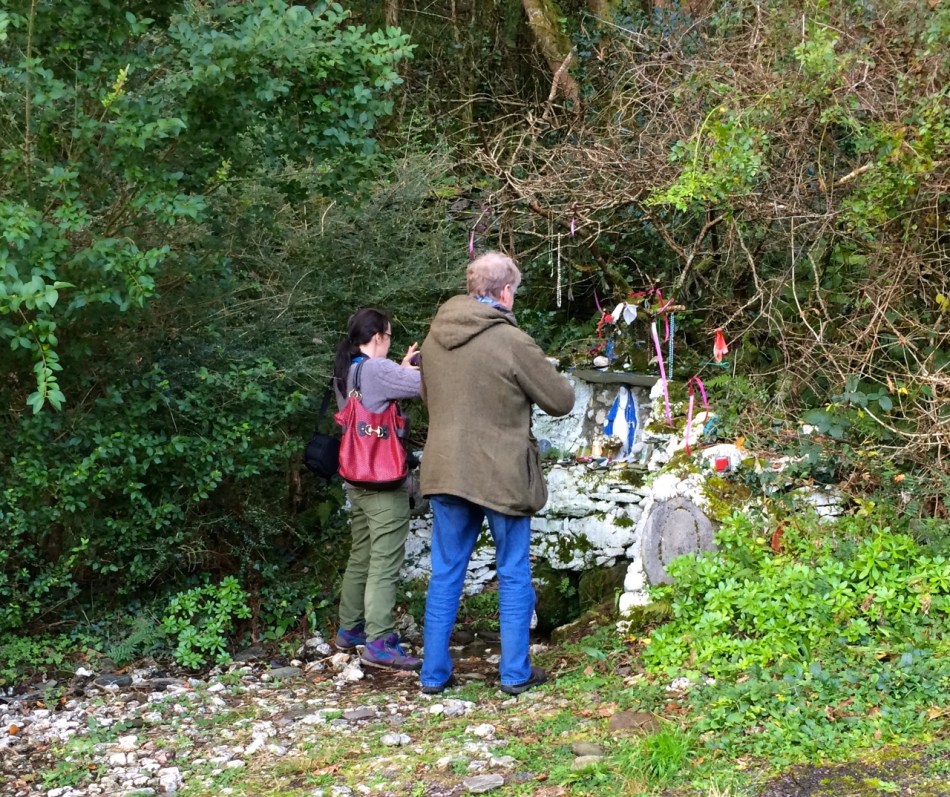 Two of the three pilgrims at a holy well