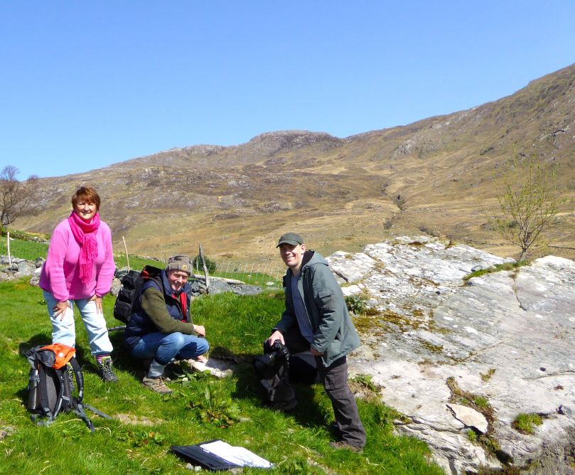 The rock art is NOT on the large panel, but on the tiny stone by Robert's knee.