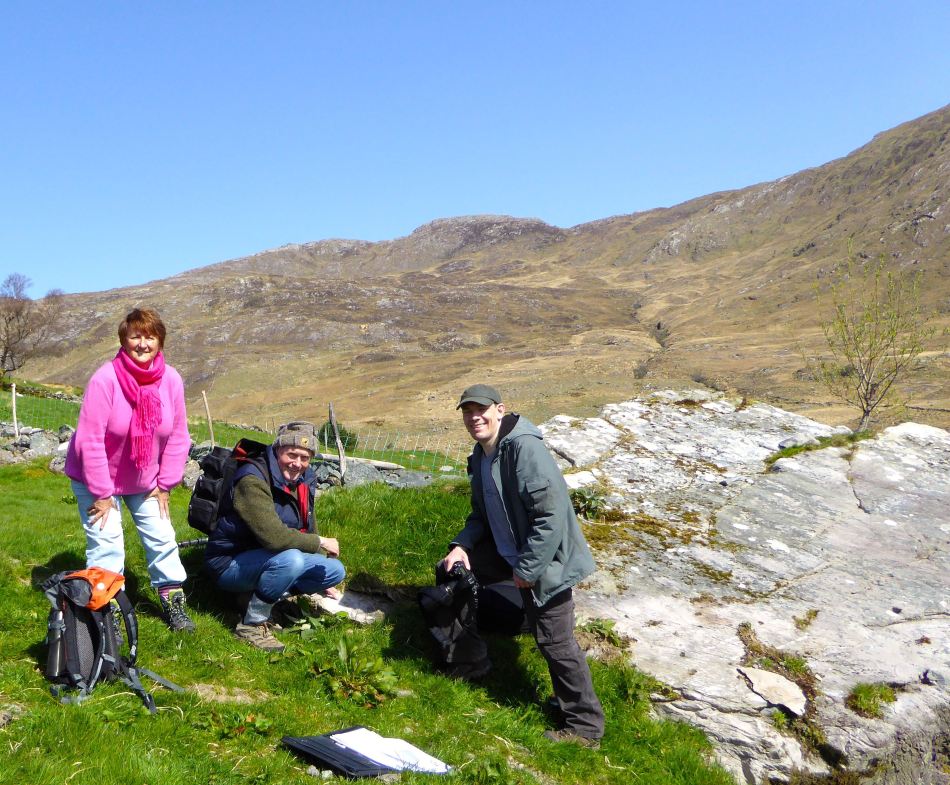 The rock art is NOT on the large panel, but on the tiny stone by Robert's knee.